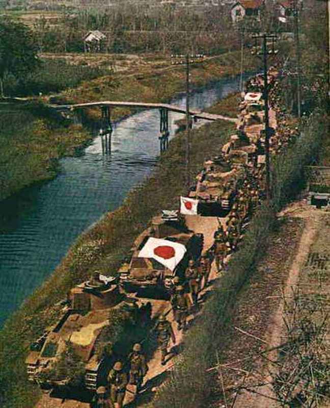 Japanese Type 89 medium tanks and infantry advancing