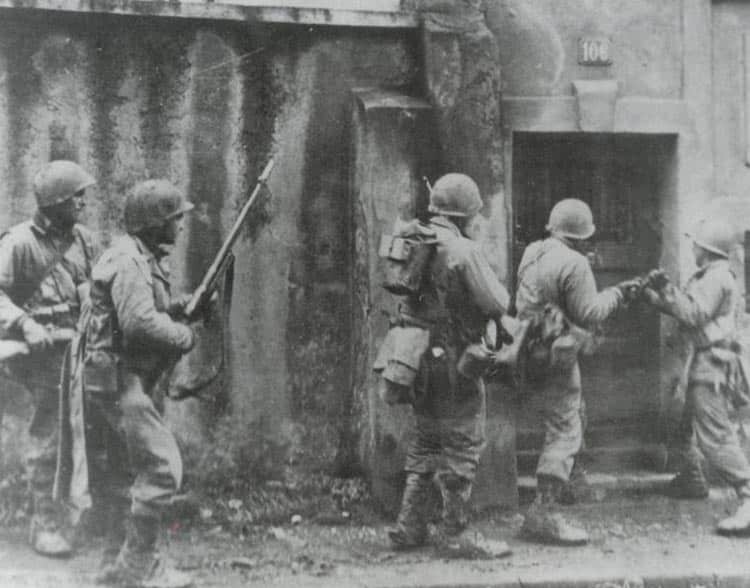 Us soldiers check houses at Metz for enemy 'stay-behinds'.
