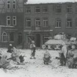 GIs from the 7th Armored Division take a watchful rest in the streets of St Vith