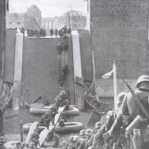 German infantry is crossing a blown up bridge over river Meuse