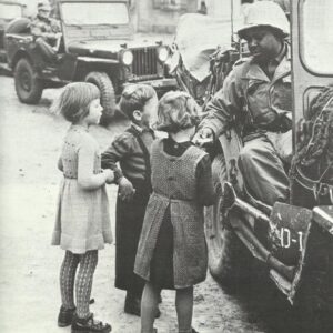 black US soldier gives off sweets to children