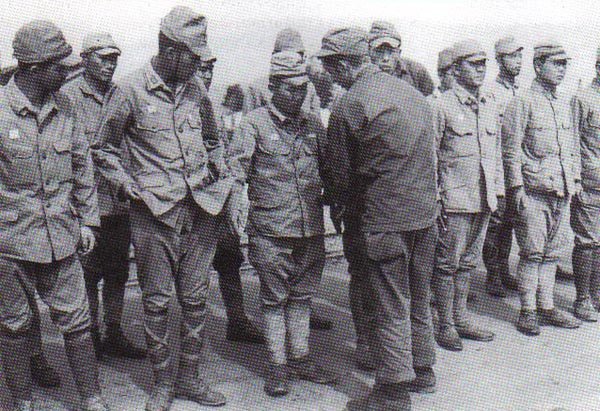 US serviceman searches prisoners