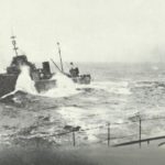 Torpedo boat next to a battleship