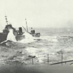 Torpedo boat next to a battleship