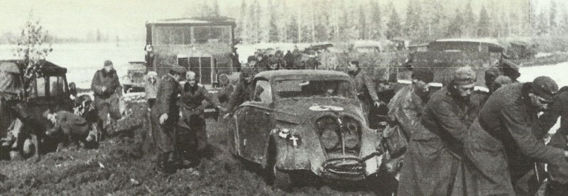 German soldiers are trying to pull a stuck vehicle out of the mud