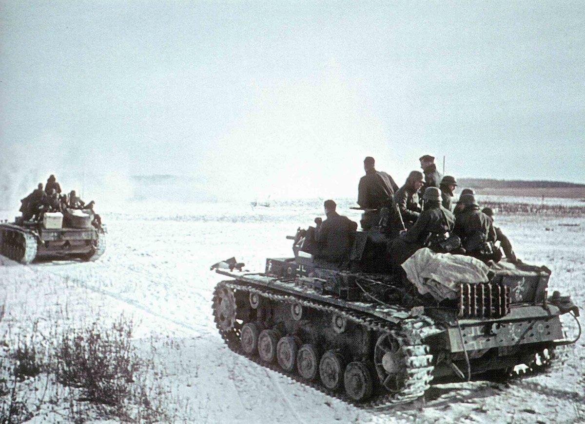 column of German Panzer III, crowded with infantrymen