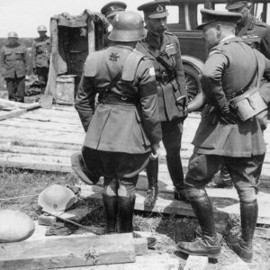 ritish staff officer demonstrates a German helmet and trench armour