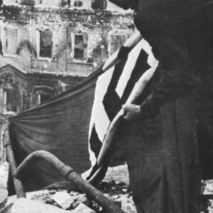German soldier hoists a Swastika flag at Stalingrad