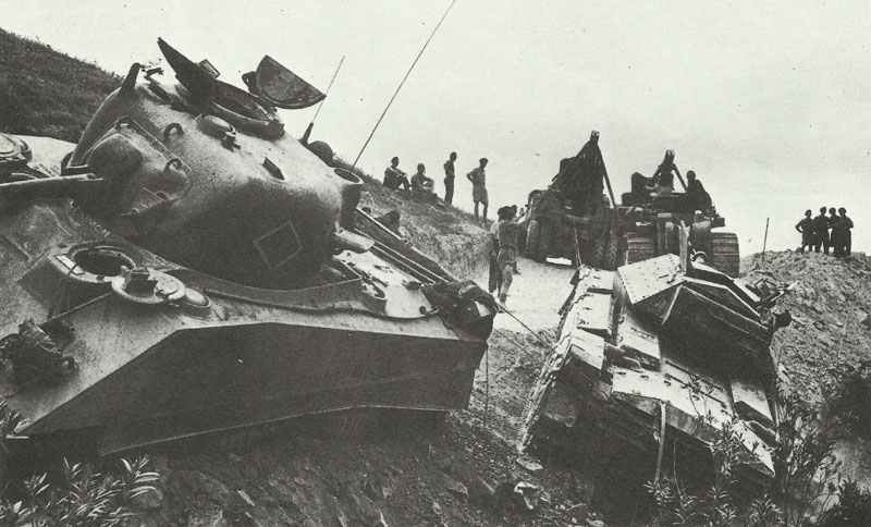 trying to pull out a Crusader and Sherman tank from a dry riverbed