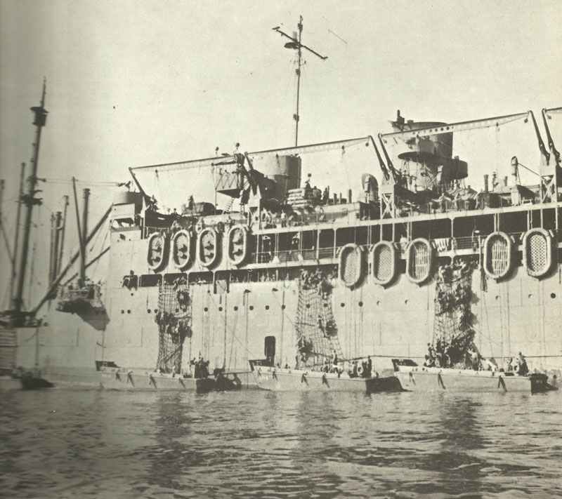 soldiers are climbing from the attack transport McCawley in landing crafts