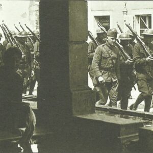 US troops march through a French village