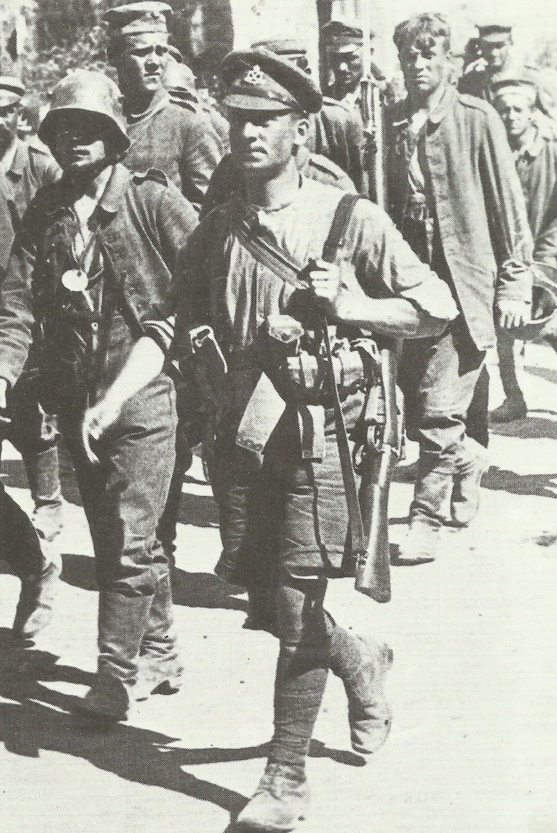 British private wearing shirtsleeves, shorts, cap and puttees