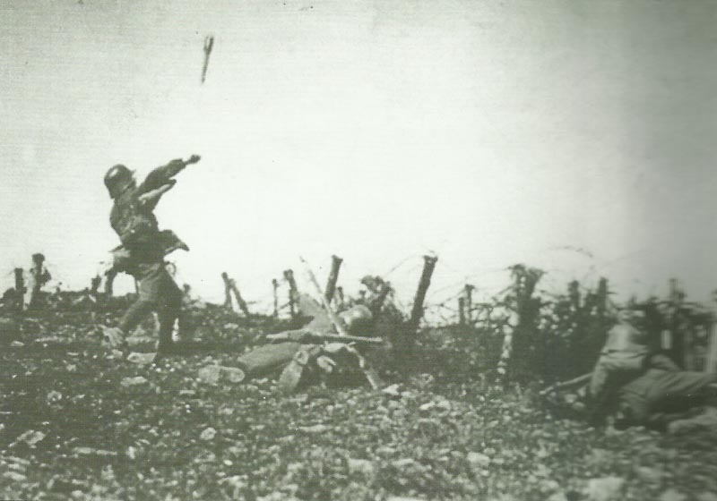 soldier throws a stick grenade