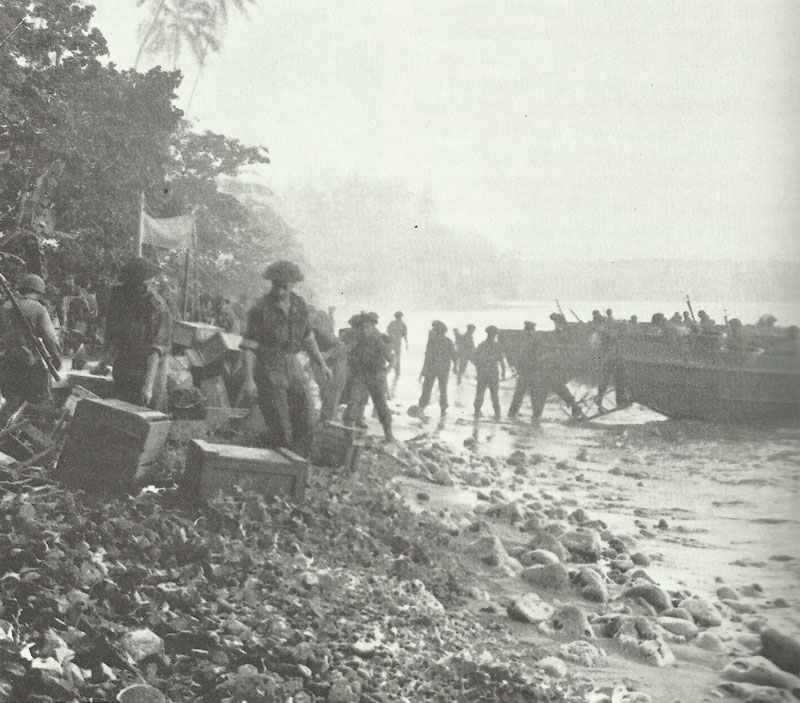 New Zealand troops of the second wave of landings unload provisions from LPCs on Treasury Island