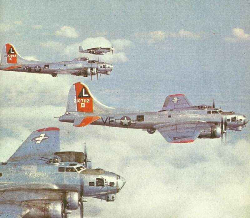 P-51B Mustang escort fighter next to a formation of B-17G