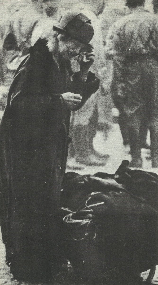 old woman with the rest of her belongings after air raid