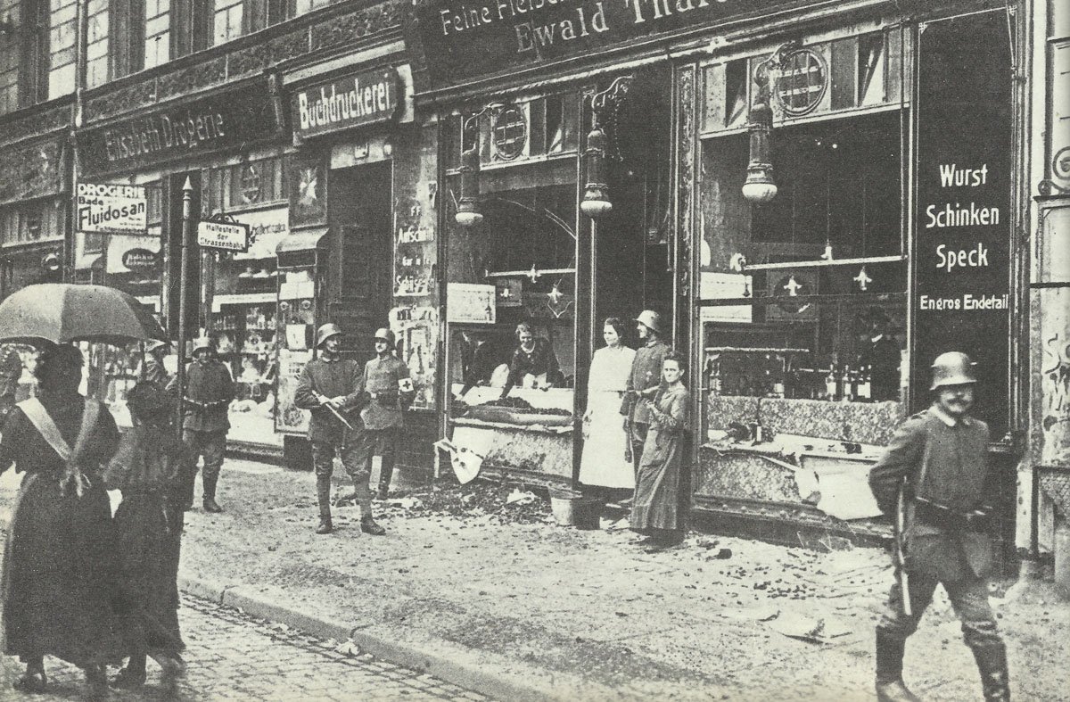 Plundered shops are guarded by government soldiers,