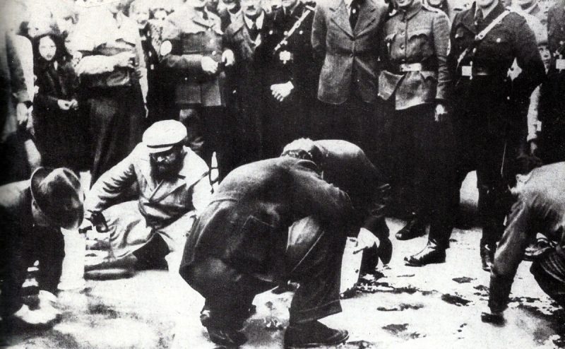 Jews clean the pavement with toothbrushes