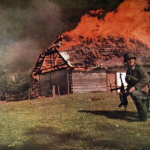 German NOC in front of a burning hut