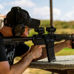 Man shooting with a rifle at an outdoor range